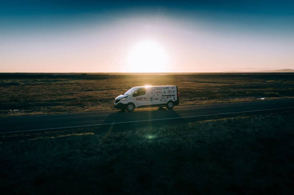 Camper van Driving in the sunset in Iceland