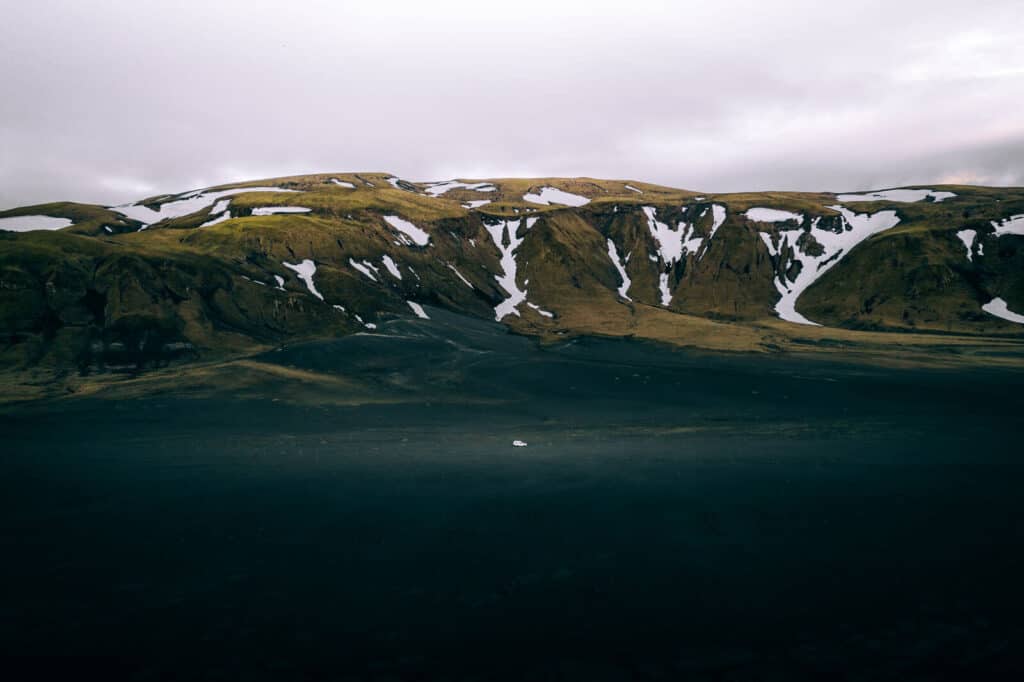 Campervan driving near mountains of Iceland