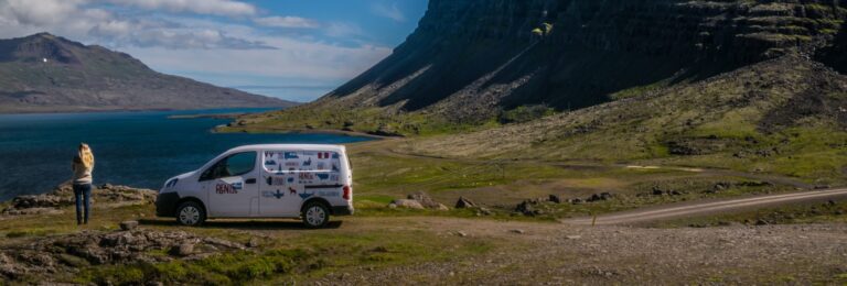 woman and campervan in the icelandic nature