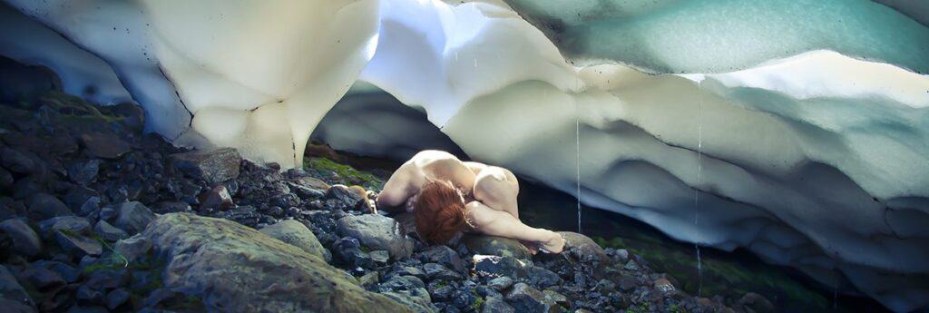 woman laying on rocks next to snow