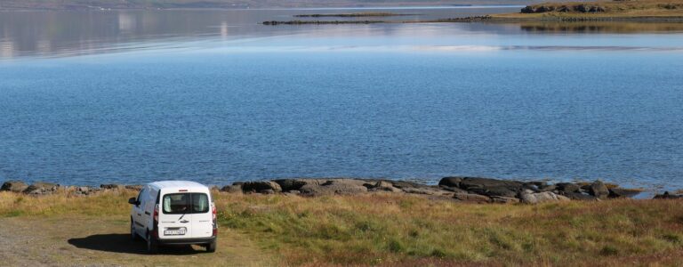 rent.is campervan parked in front of a lake