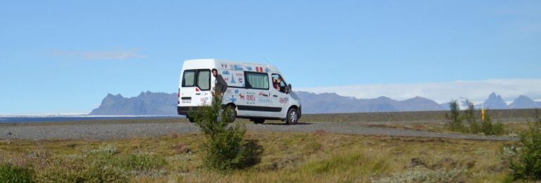 Family inside a rent.is camper van on the road