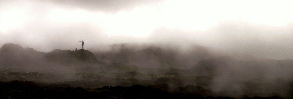 man standing in the mist in Reykjadalur in Iceland
