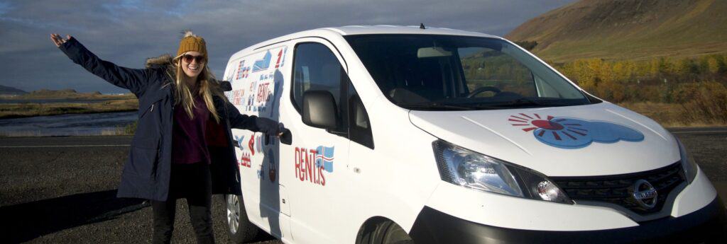 woman smiling opening a rent.is camper van