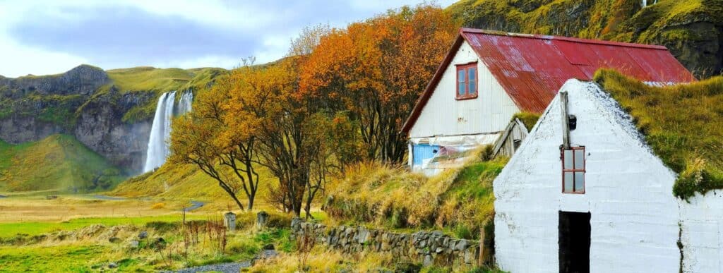 Old farmhouses and a waterfall in Iceland