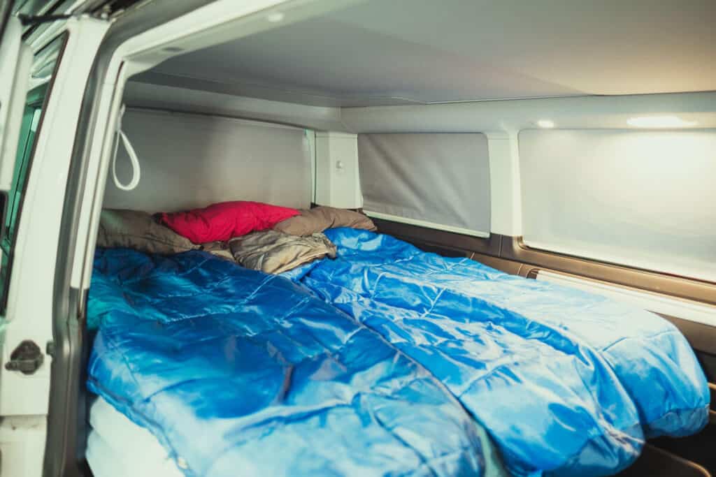 VW California 4×4 camper interior sleeping area, sleeping bags, pillows