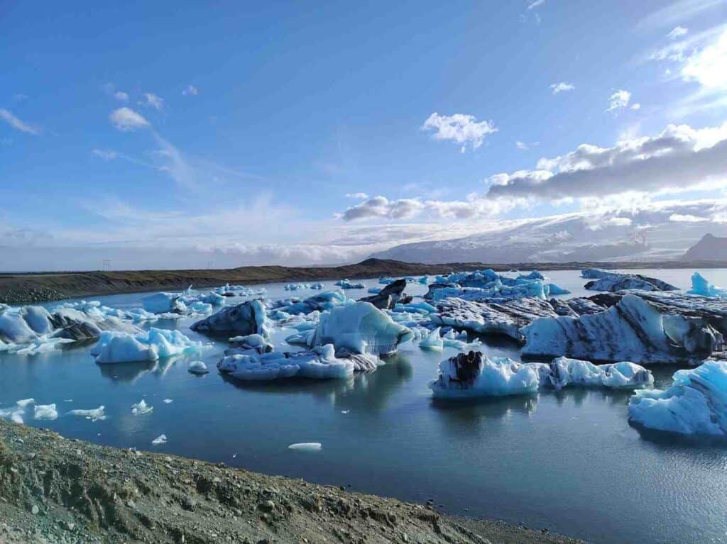 A lake with small glaciers floating through.