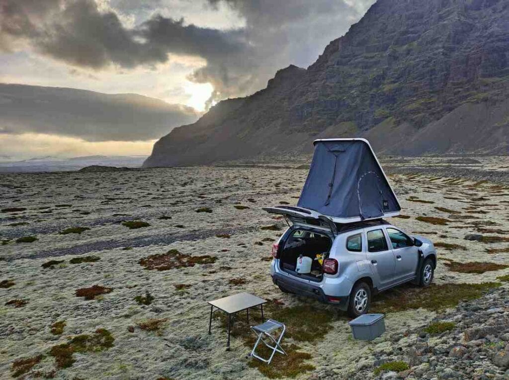 Dacia duster camper with roof tent camped in the icelandic nature