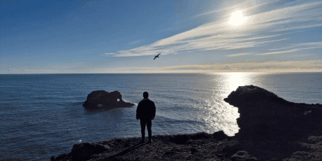 man looking at the ocean view in Iceland