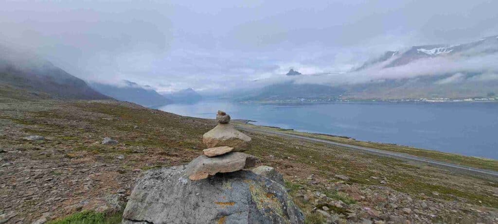 A rock stack looking out at a fjord.