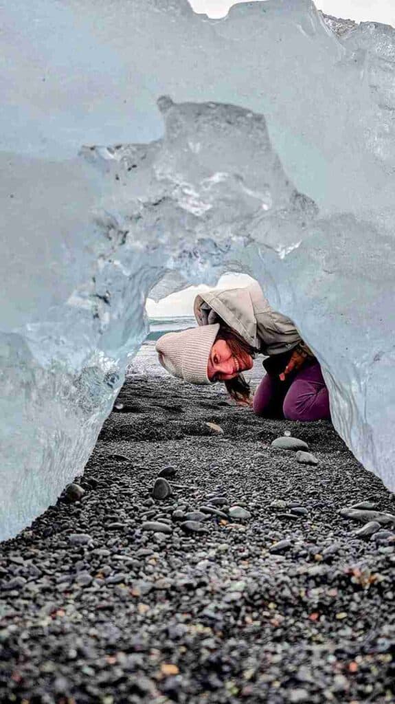 A woman looking through a large ice with a hole.
