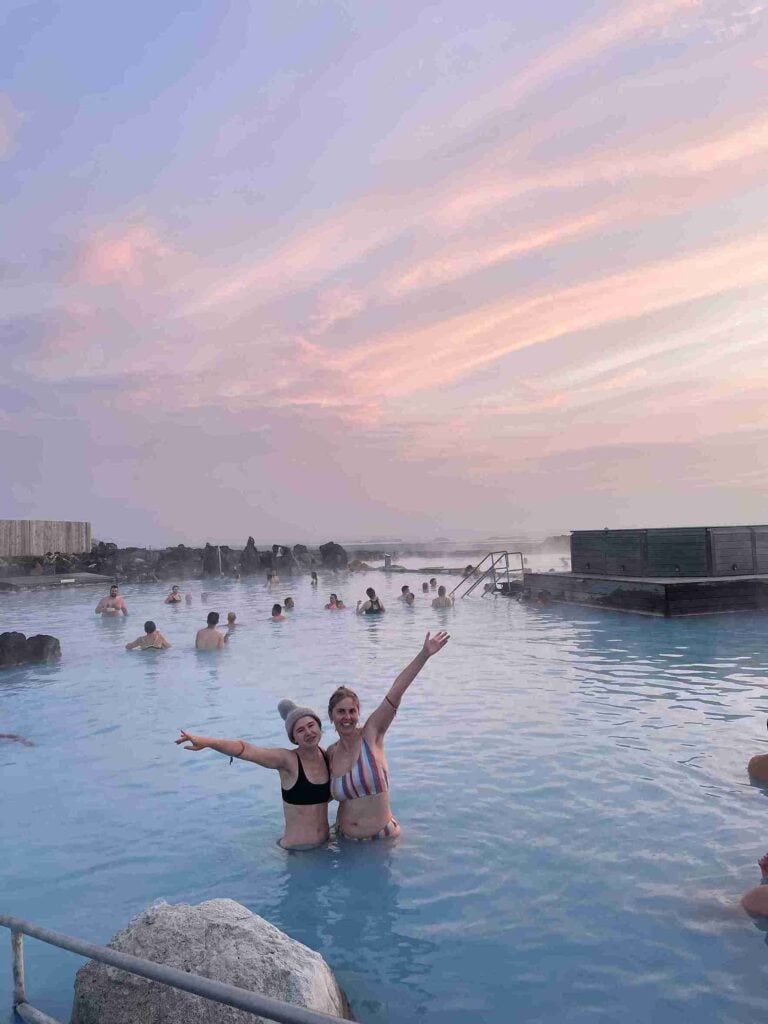 Wild girls standing in the blue water of Mývatn naturebaths.