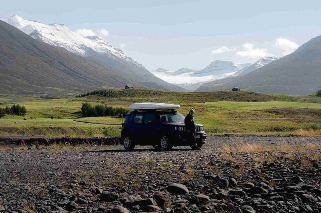 A woman poses by the hood of the jeep renegade