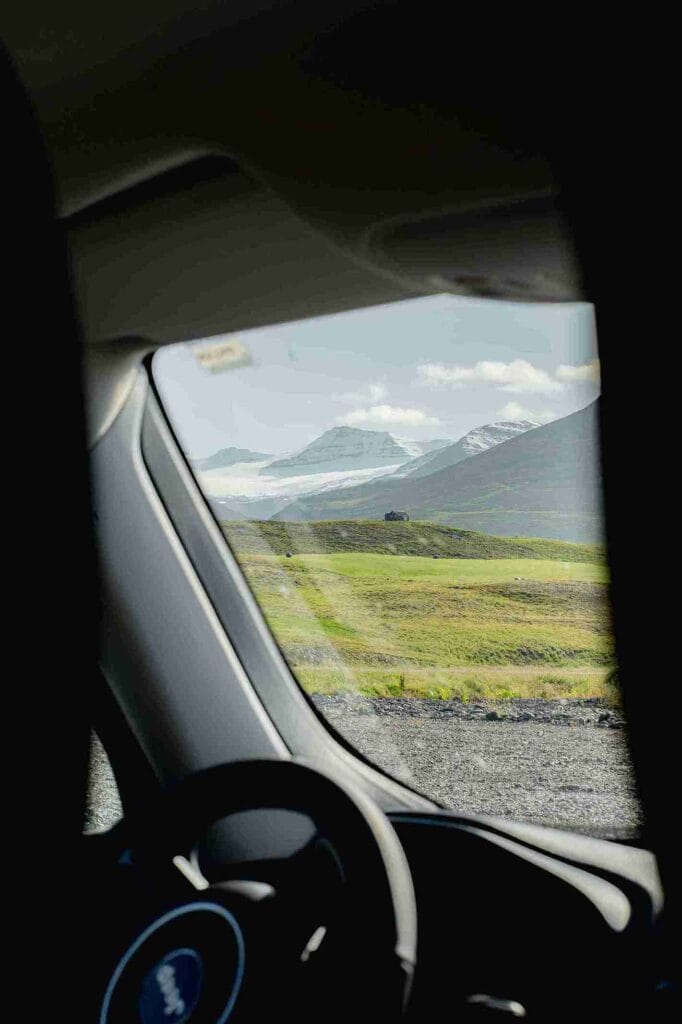 looking out of the window at a grassy field 