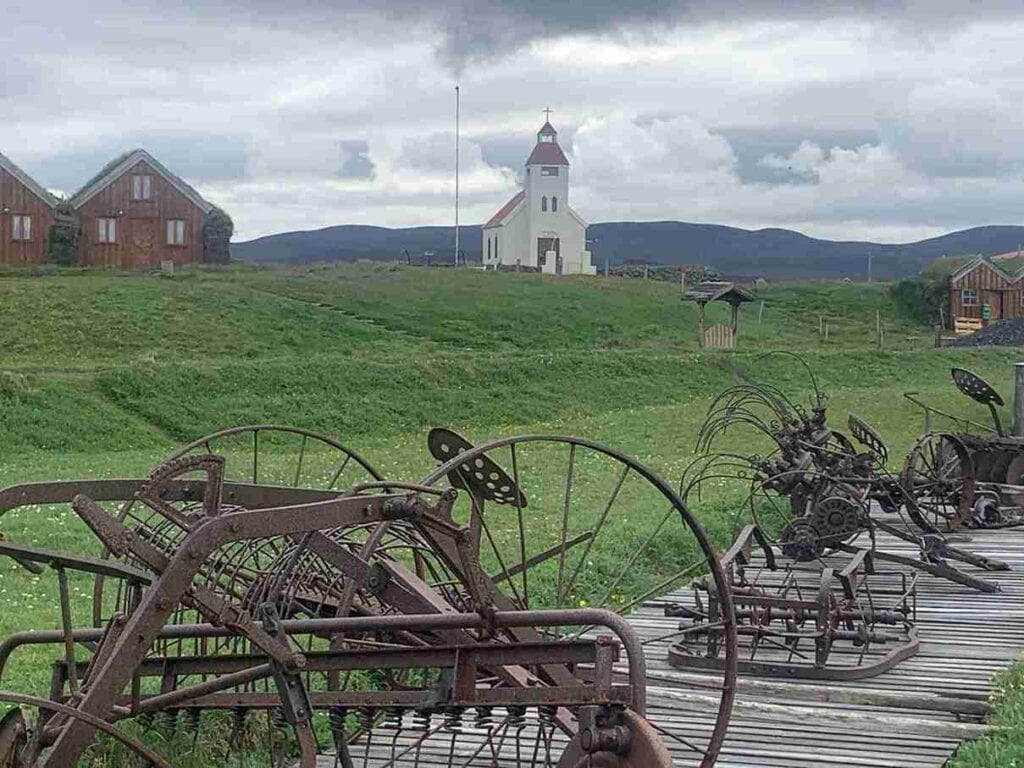 An old church on top of a grassy hill