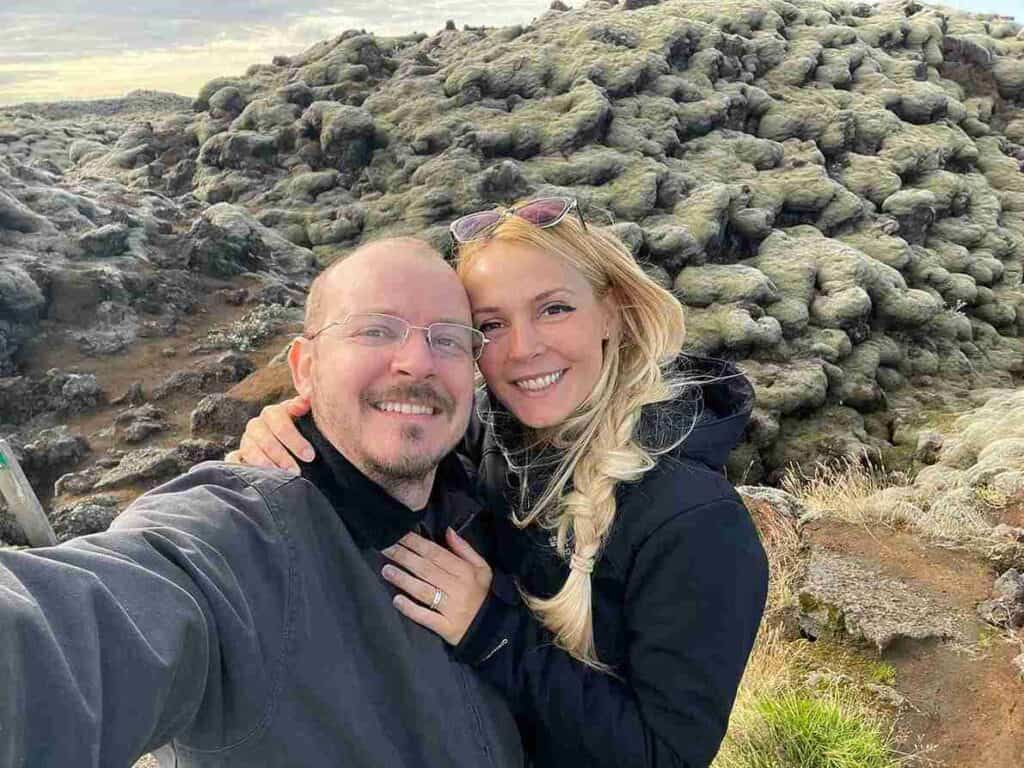 A couple standing by dunes