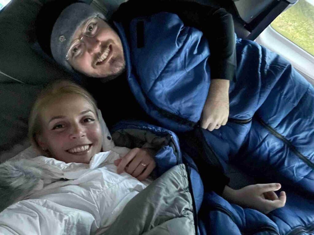 A couple cuddled up in camper