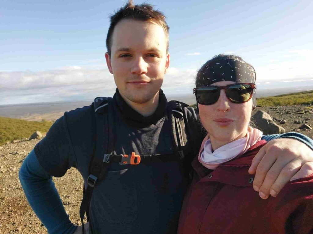 A couple standing on a mountain