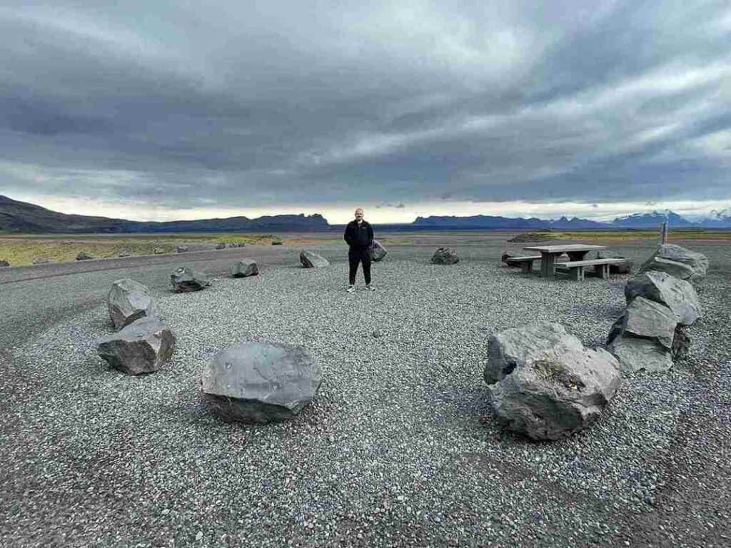 A man standing in the middle of a rock circle