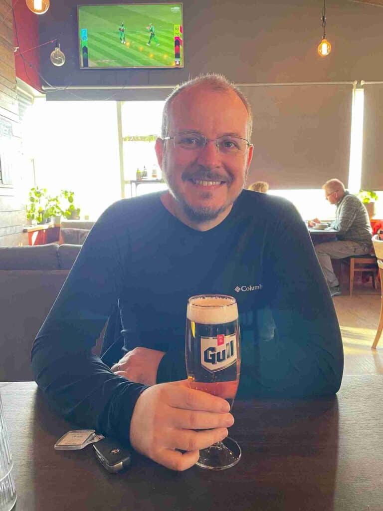 A man in a pub with a beer